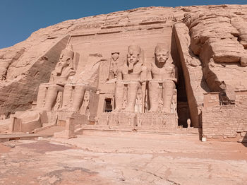 Abu simbel, an ancient tomb carved on the stone with statues in egypt, africa