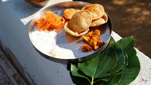 Hindu religious man offering food placed on a  leaf during a hindu ritual in the month of sharada.