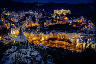 High angle view of illuminated buildings in city at night