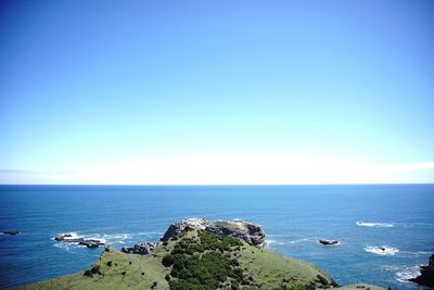 Scenic view of sea against clear blue sky