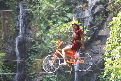 Side view of woman riding bicycle