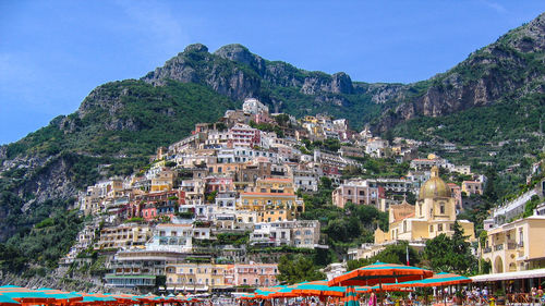 High angle view of townscape by mountain against sky