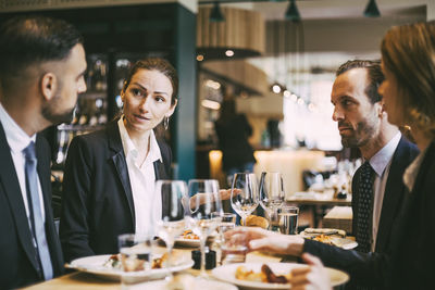 Business coworkers communicating at lunch in restaurant