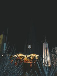 Illuminated buildings against clear sky at night