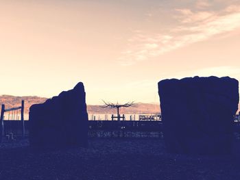 Built structures against sky at sunset