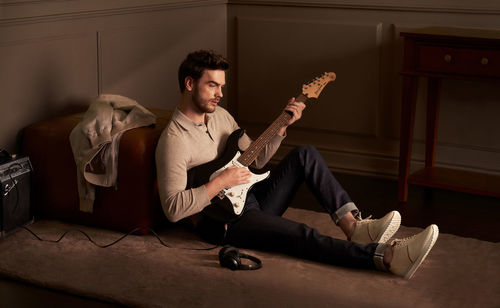 Portrait of woman playing guitar