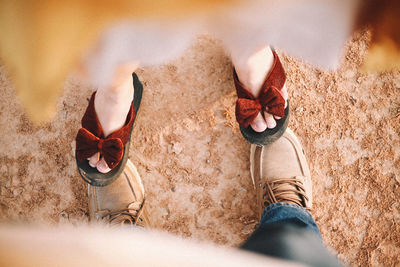 Low section of couple standing at beach