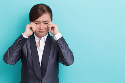 Mid adult woman against blue background