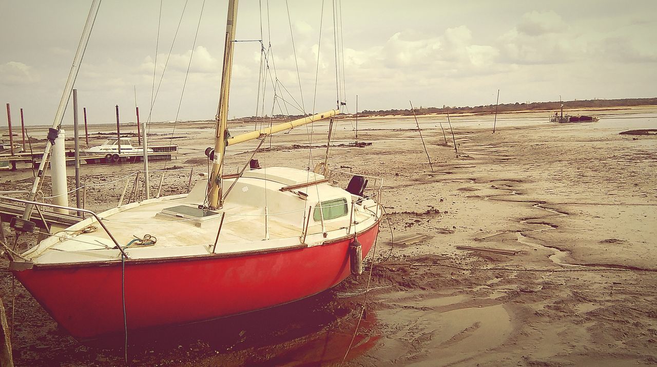 beach, sand, sea, shore, sky, water, nautical vessel, moored, horizon over water, boat, abandoned, day, tranquility, outdoors, transportation, nature, cloud - sky, wood - material, no people, tranquil scene