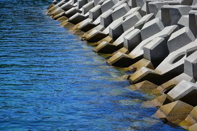 High angle view of deck chairs by sea