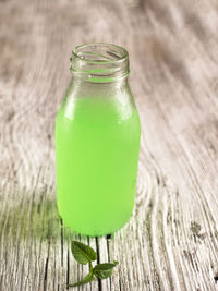 Fresh cold green lemonade with mint in glass bottle