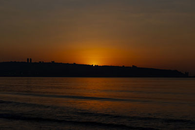 Scenic view of sea against romantic sky at sunset