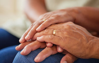 Cropped image of couple holding hands