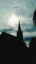Low angle view of silhouette building against sky