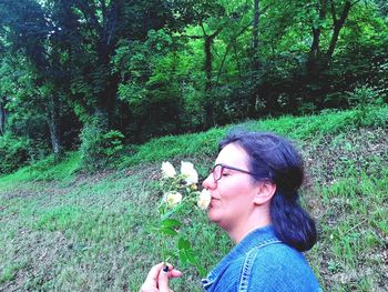 Portrait of woman looking at camera in forest