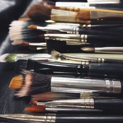 Close-up of make-up brushes on table