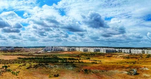 Scenic view of landscape against cloudy sky
