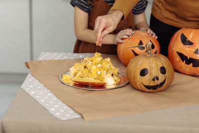 Midsection of woman holding food on table