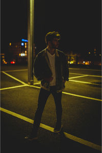 Full length of man looking at illuminated city