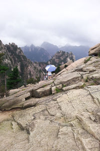 Scenic view of mountains against cloudy sky