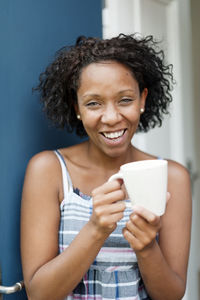 Smiling woman holding cup