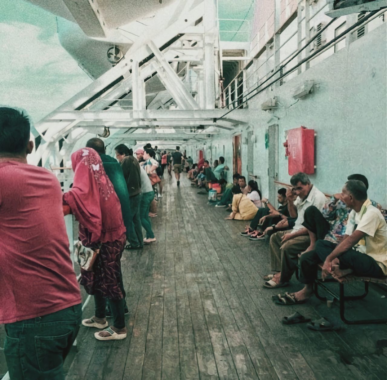 GROUP OF PEOPLE WALKING ON ROAD IN BUILDING