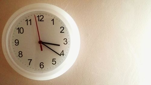 Close-up of clock on wall at home