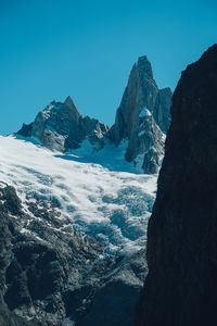 Scenic view of snowcapped mountains against clear blue sky