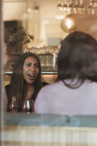 Multiracial female and male friends celebrating during party at restaurant