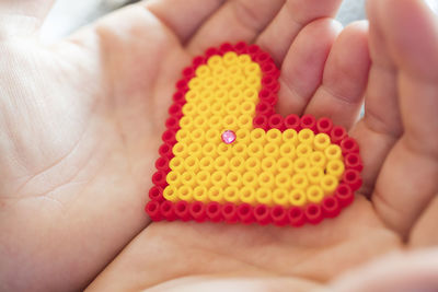 High angle view of woman holding multi colored baby