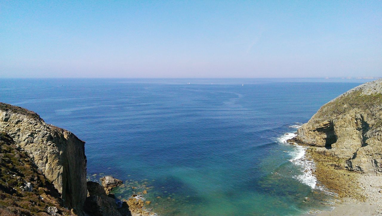 sea, horizon over water, water, blue, scenics, tranquil scene, beauty in nature, tranquility, clear sky, copy space, nature, rock - object, idyllic, rock formation, sky, high angle view, seascape, day, coastline, outdoors