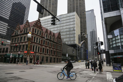 People on city street amidst buildings