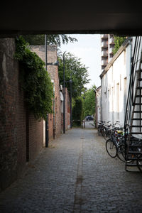 Footpath amidst buildings in city