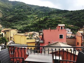 Houses on mountain against sky