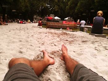 Low section of woman relaxing on beach