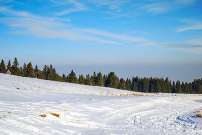 Scenic view of snow covered landscape against sky