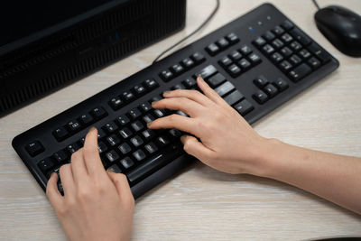 High angle view of woman using laptop on table