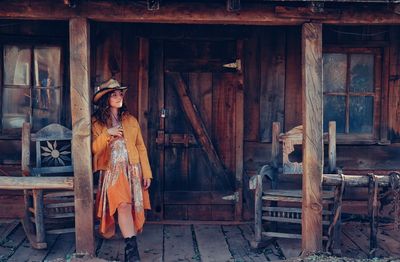 Woman standing in front of hut