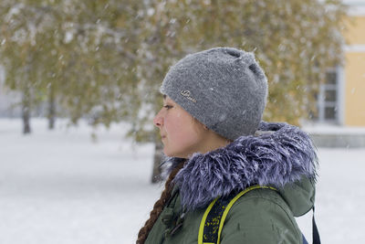 Close-up of girl in front of covered tree