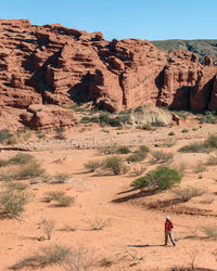 Full length of man on rock formations in desert