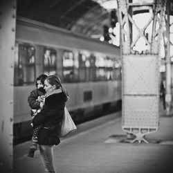 Woman standing on train station platform
