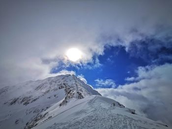 Scenic view of snow covered mountains against sky