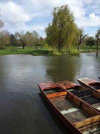 Boats moored in lake against sky