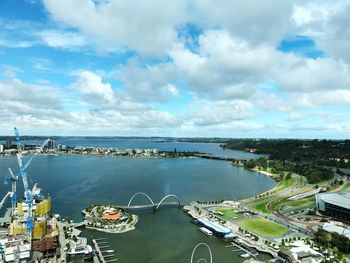 High angle view of road by sea against cloudy sky