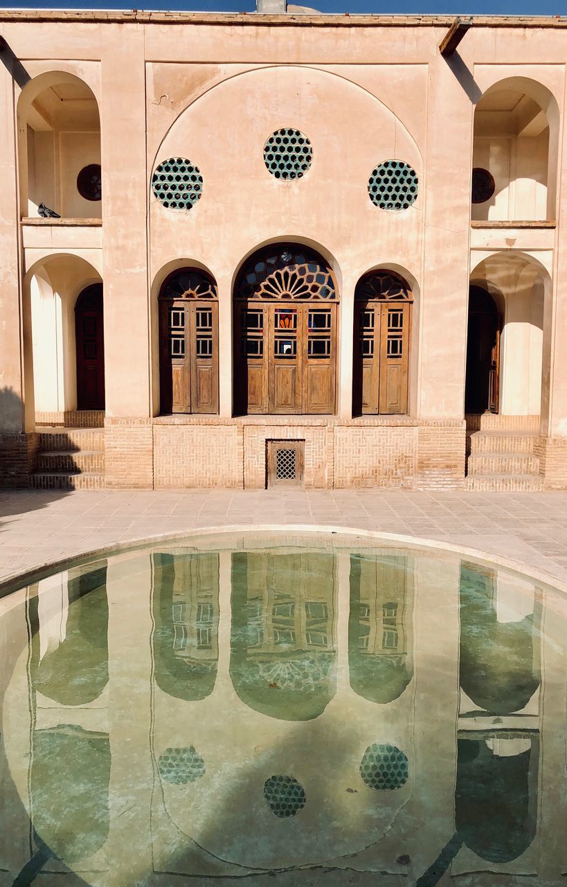 REFLECTION OF BUILDINGS ON SWIMMING POOL