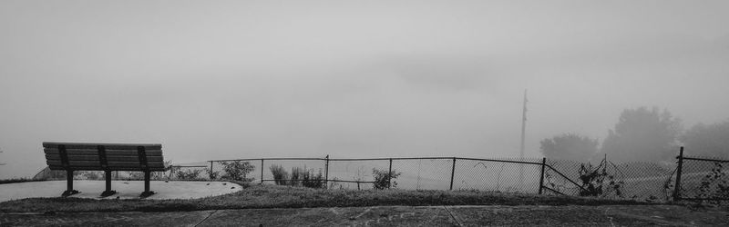 Fence on field against sky