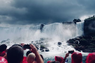 People photographing waterfall