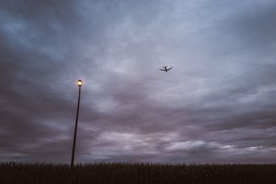 Low angle view of airplane flying against sky