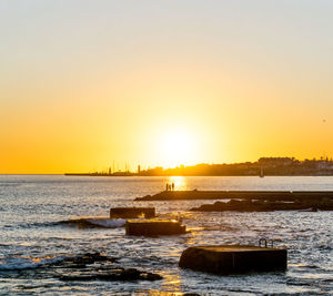 Scenic view of sea against clear sky during sunset
