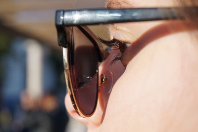 Close-up of woman in sunglasses at home